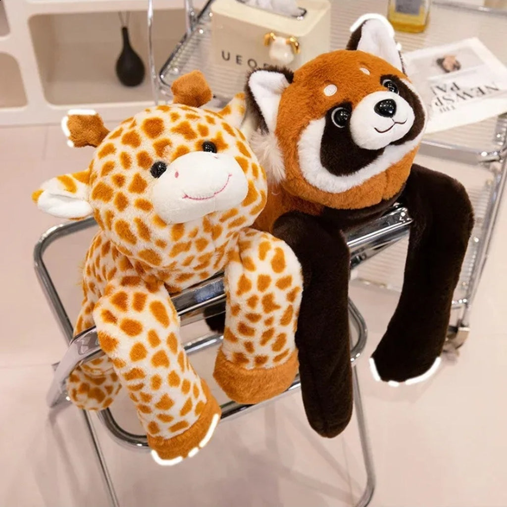Long-arm weighted giraffe and red panda plushies sitting on a chair